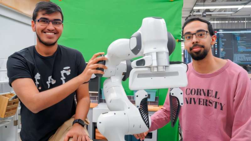Kushal Kedia (left), a doctoral student in the field of computer science, and Prithwish Dan are members of the development team behind RHyME, a system that allows robots to learn tasks by watching a single how-to video. Credit: Louis DiPietro